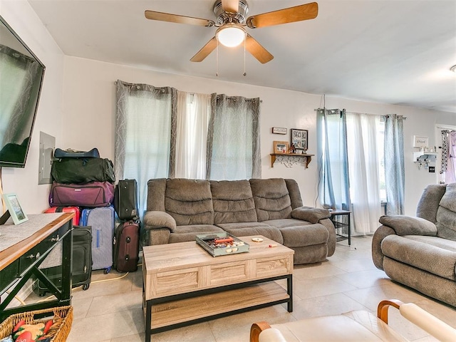 living room featuring ceiling fan and light tile patterned floors