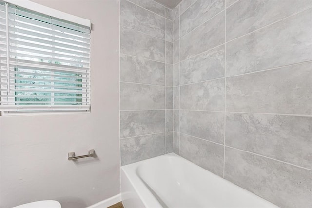 3128 NW 44th St, Oklahoma City, OK 73112 - bathroom featuring baseboards, a tub to relax in, a shower, and toilet