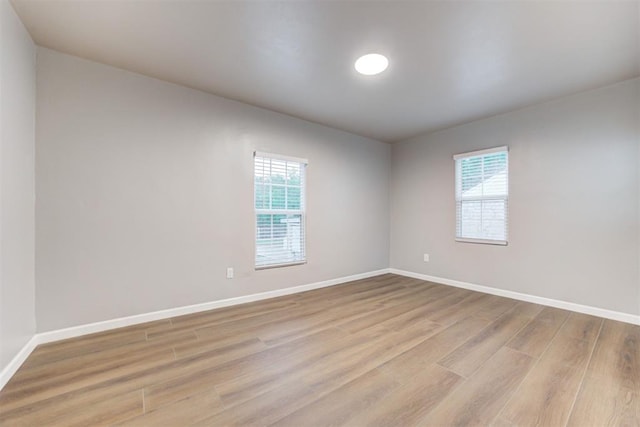 3128 NW 44th St, Oklahoma City, OK 73112 - empty room featuring healthy amount of natural light, light wood-style flooring, and baseboards