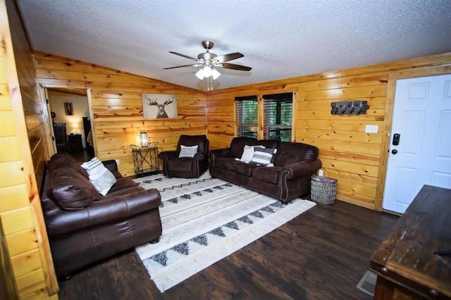 78 Lionfish Rd, Broken Bow, OK 74728 - living room featuring vaulted ceiling, wood walls, dark wood-style flooring, a textured ceiling, and a ceiling fan