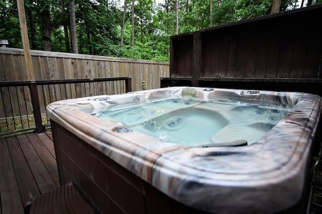 78 Lionfish Rd, Broken Bow, OK 74728 - deck with a hot tub, fence, and a forest view
