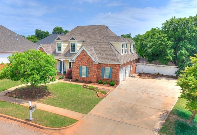 404 Nantucket Blvd, Norman, OK 73071 - traditional home with a garage, driveway, brick siding, and a shingled roof
