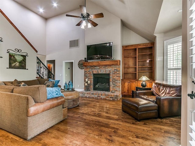 404 Nantucket Blvd, Norman, OK 73071 - living area featuring a ceiling fan, wood finished floors, stairway, a brick fireplace, and high vaulted ceiling