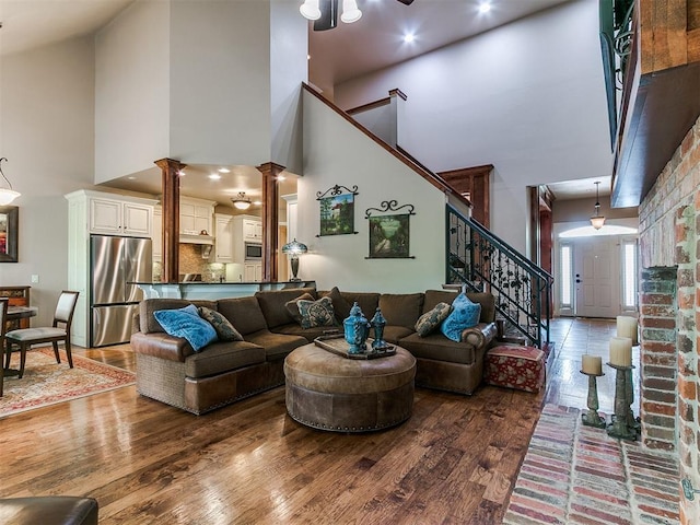 404 Nantucket Blvd, Norman, OK 73071 - living area featuring a high ceiling, stairway, and wood finished floors