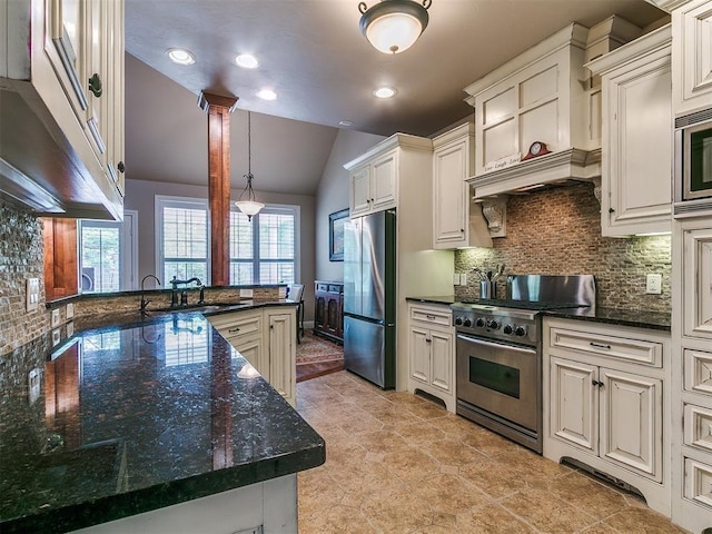 404 Nantucket Blvd, Norman, OK 73071 - kitchen with stainless steel appliances, a sink, vaulted ceiling, healthy amount of natural light, and tasteful backsplash
