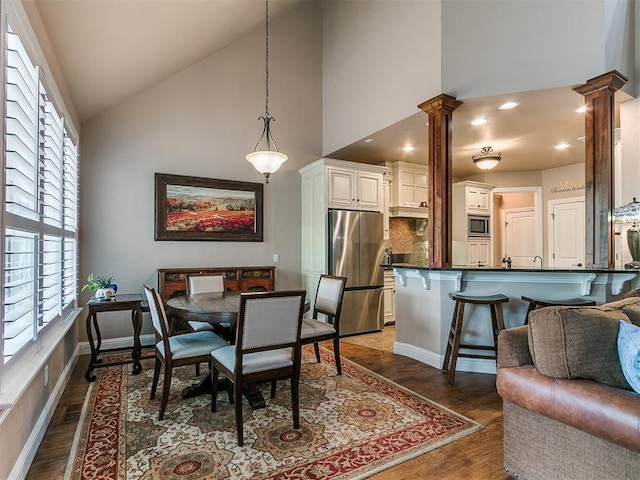 404 Nantucket Blvd, Norman, OK 73071 - dining space with decorative columns, high vaulted ceiling, plenty of natural light, wood finished floors, and recessed lighting