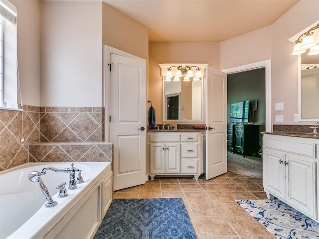 404 Nantucket Blvd, Norman, OK 73071 - bathroom featuring a bath, two vanities, and tile patterned floors