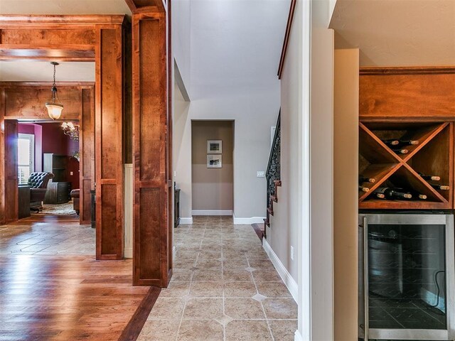 404 Nantucket Blvd, Norman, OK 73071 - hallway featuring wine cooler, light wood finished floors, and baseboards