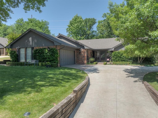 view of front of home featuring concrete driveway, a garage, a front lawn, and brick siding