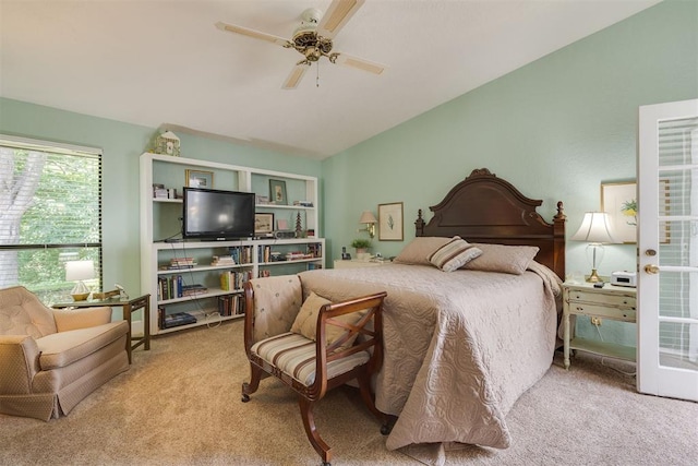carpeted bedroom featuring vaulted ceiling and ceiling fan