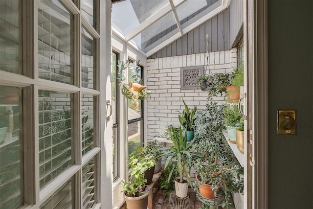 sunroom / solarium with vaulted ceiling and a skylight
