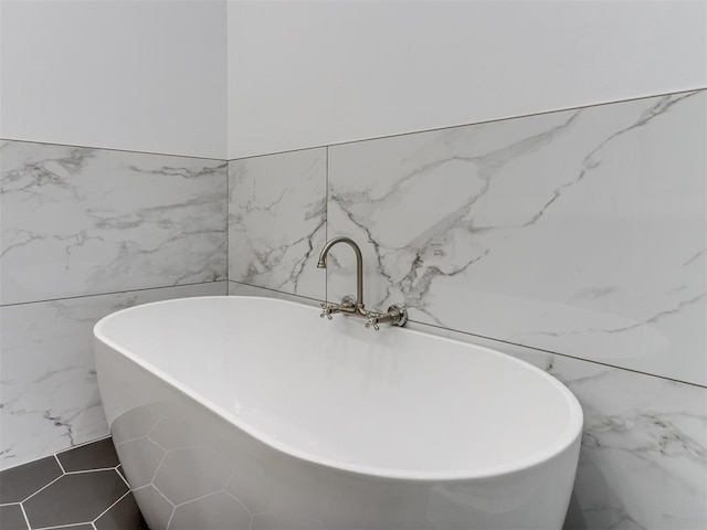 1518 NW 8th St, Oklahoma City, OK 73106 - bathroom featuring tile walls and a freestanding bath