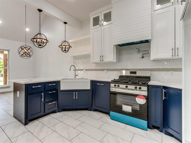 1518 NW 8th St, Oklahoma City, OK 73106 - kitchen featuring stainless steel gas stove, a sink, a peninsula, and white cabinetry