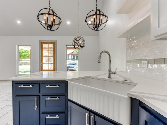 1518 NW 8th St, Oklahoma City, OK 73106 - kitchen with a chandelier, a sink, blue cabinets, lofted ceiling, and recessed lighting