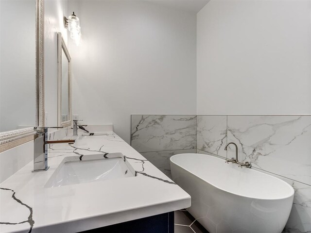 1518 NW 8th St, Oklahoma City, OK 73106 - full bathroom with tile walls, a freestanding tub, double vanity, and wainscoting