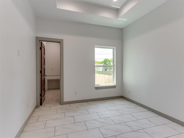 1518 NW 8th St, Oklahoma City, OK 73106 - empty room featuring a raised ceiling and baseboards