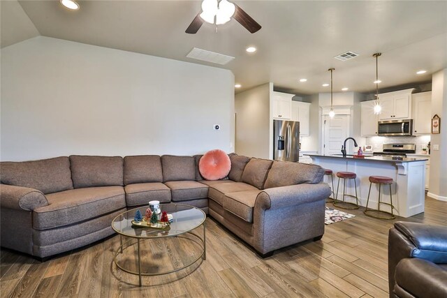 1425 NW 12th St, Newcastle, OK 73065 - living room featuring wood finished floors, ceiling fan, recessed lighting, and lofted ceiling