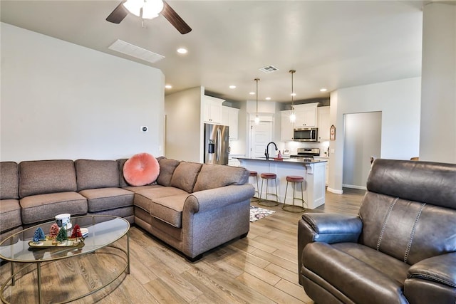 1425 NW 12th St, Newcastle, OK 73065 - living room featuring light wood-style flooring, a ceiling fan, and recessed lighting