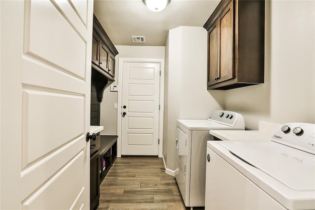 1425 NW 12th St, Newcastle, OK 73065 - clothes washing area featuring separate washer and dryer, wood finished floors, cabinet space, and baseboards