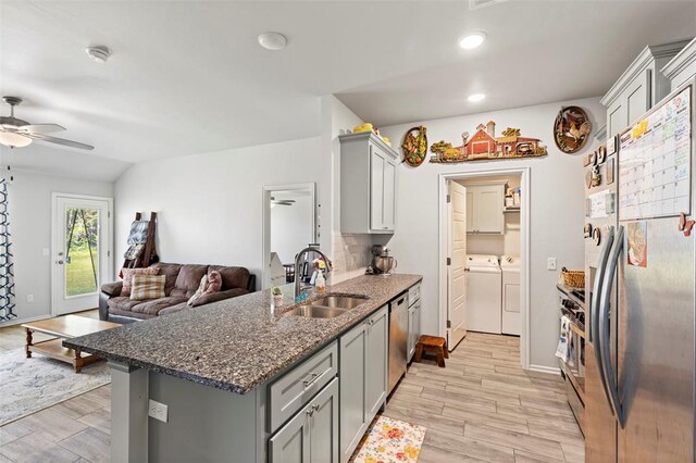 12509 NE 36th Sts, Spencer, OK 73084 - kitchen featuring appliances with stainless steel finishes, a sink, washer and dryer, gray cabinetry, and recessed lighting