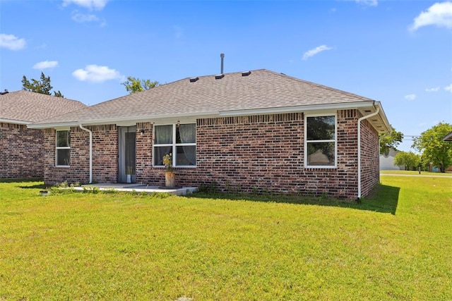 12509 NE 36th Sts, Spencer, OK 73084 - back of house featuring a shingled roof, brick siding, and a yard