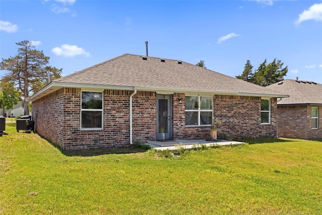 12509 NE 36th Sts, Spencer, OK 73084 - rear view of house with a shingled roof, brick siding, a lawn, and a patio area