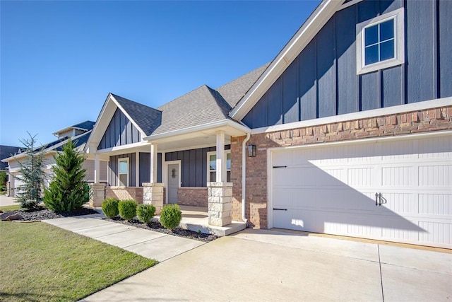14205 Village Creek Way, Piedmont, OK 73078 - craftsman inspired home featuring roof with shingles, a porch, concrete driveway, board and batten siding, and brick siding