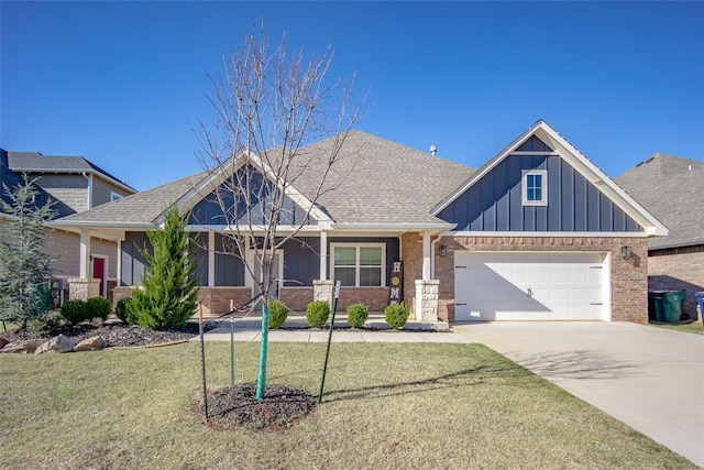 14205 Village Creek Way, Piedmont, OK 73078 - view of front of home featuring board and batten siding, an attached garage, concrete driveway, a front lawn, and a porch