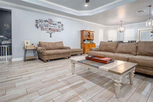 14205 Village Creek Way, Piedmont, OK 73078 - living area featuring a chandelier, wood finish floors, a raised ceiling, crown molding, and baseboards