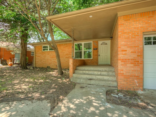 doorway to property featuring brick siding