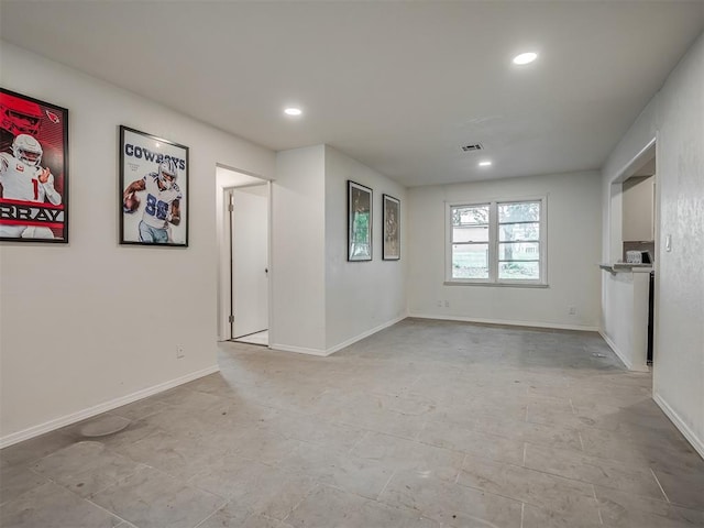 unfurnished living room with recessed lighting and baseboards