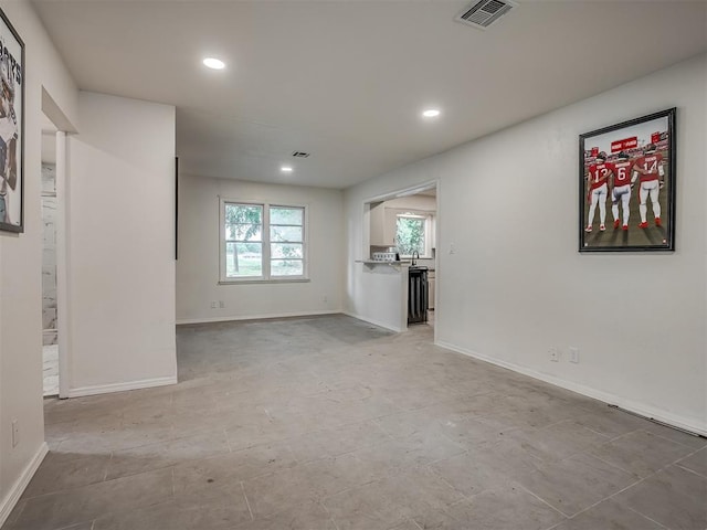 unfurnished living room featuring recessed lighting and baseboards
