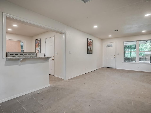 empty room featuring recessed lighting and baseboards