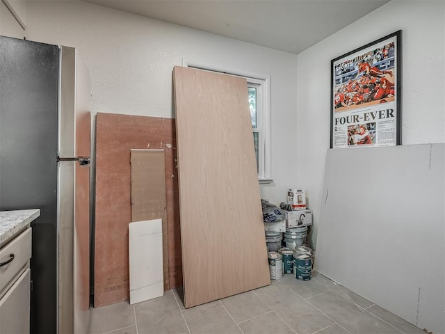 clothes washing area featuring light tile patterned flooring