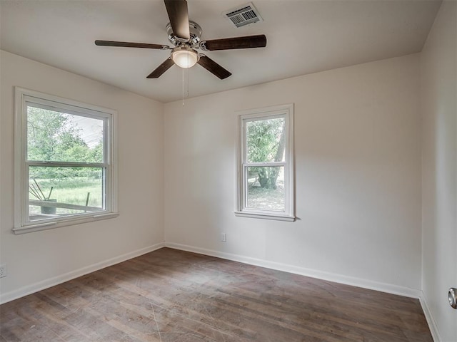 unfurnished room with wood finished floors, baseboards, and a ceiling fan