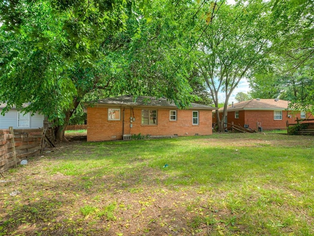 back of house with crawl space and brick siding
