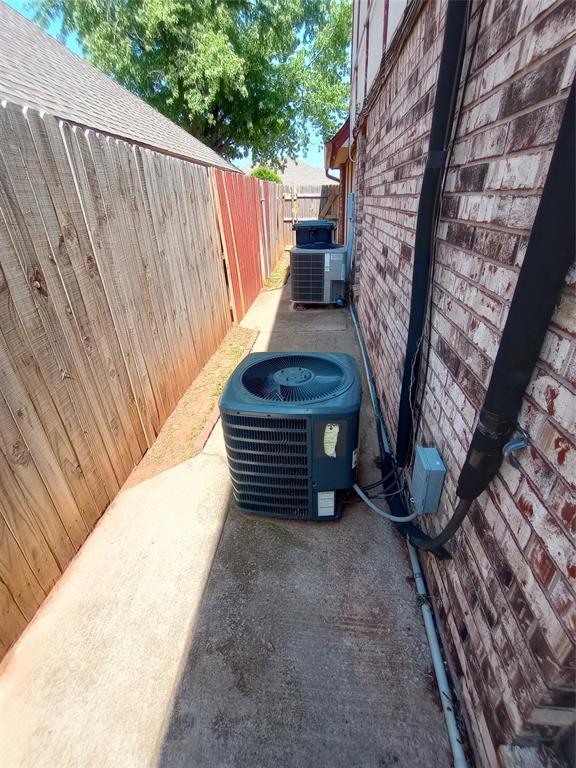 11209 Cimarron Dr, Oklahoma City, OK 73162 - exterior view of a central air condition unit and brick siding