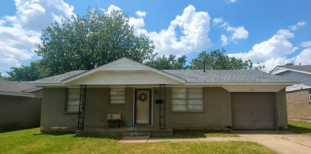 view of front of property featuring concrete driveway, a garage, roof with shingles, and a front lawn