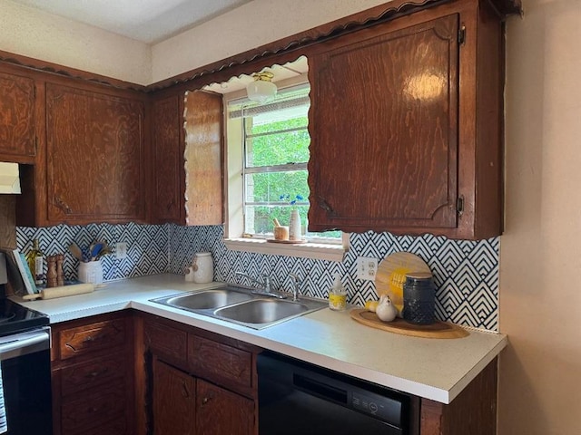 kitchen with a sink, black dishwasher, range with electric cooktop, and light countertops