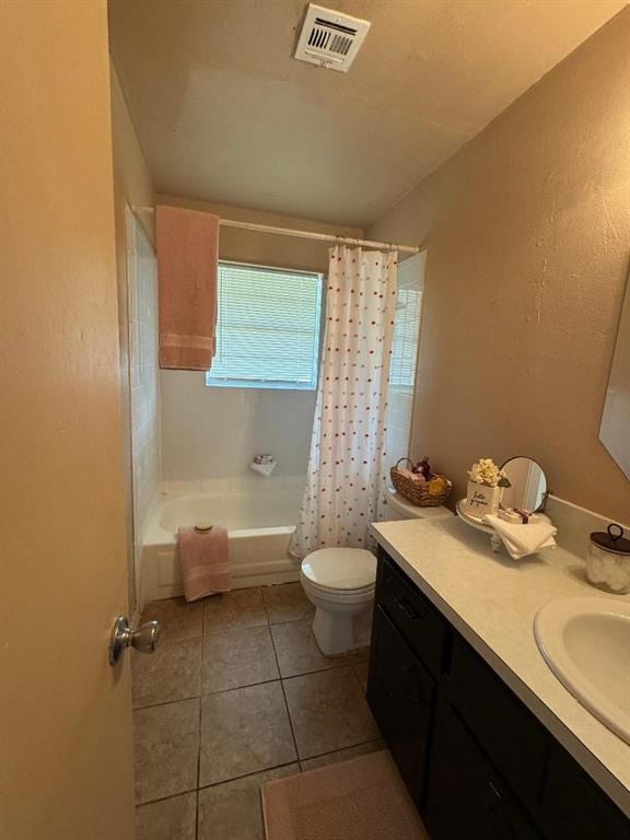 full bathroom featuring tile patterned flooring, toilet, vanity, shower / bath combo, and a textured wall