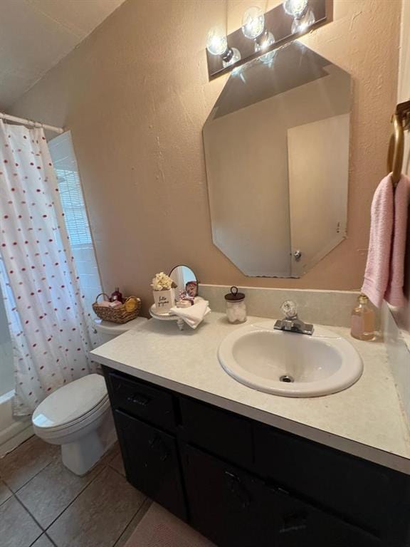 bathroom featuring vanity, tile patterned flooring, and toilet