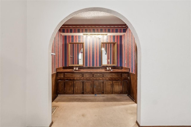 3109 N Glade Ave, Bethany, OK 73008 - corridor featuring arched walkways, light colored carpet, and a sink