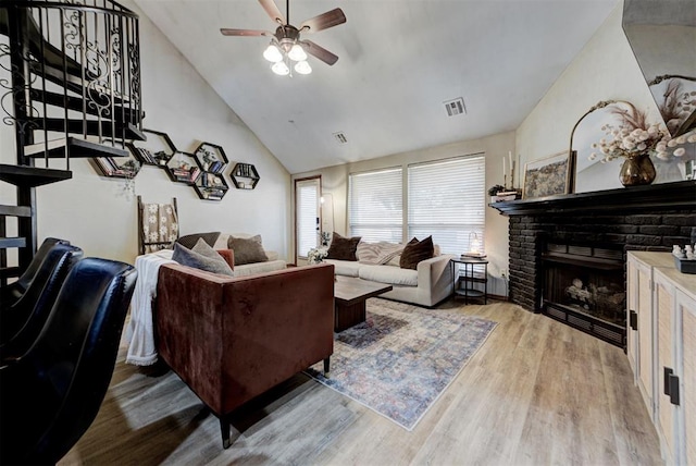 17009 Picasso Dr, Oklahoma City, OK 73170 - living room with a ceiling fan, stairway, wood finished floors, a brick fireplace, and high vaulted ceiling