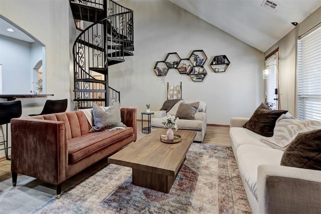 17009 Picasso Dr, Oklahoma City, OK 73170 - living room with arched walkways, stairs, healthy amount of natural light, vaulted ceiling, and wood finished floors