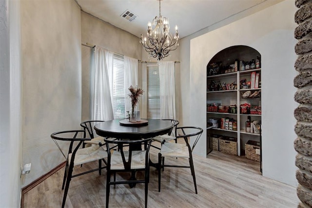 17009 Picasso Dr, Oklahoma City, OK 73170 - dining room featuring a chandelier and light wood-style flooring