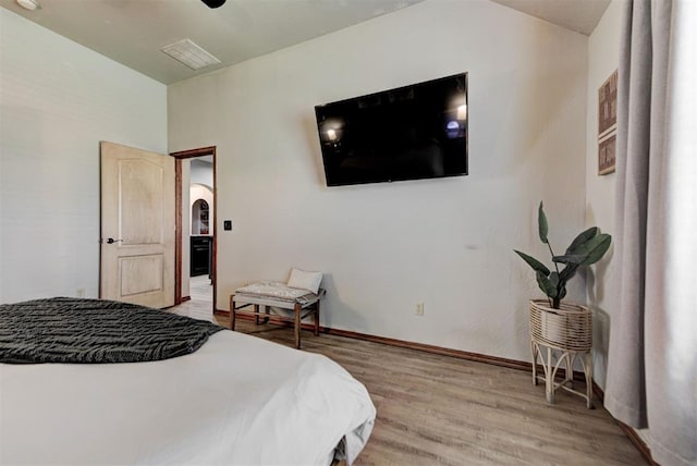 17009 Picasso Dr, Oklahoma City, OK 73170 - bedroom featuring light wood-style floors, baseboards, arched walkways, and ceiling fan