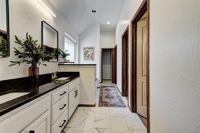 17009 Picasso Dr, Oklahoma City, OK 73170 - full bathroom with double vanity, marble finish flooring, lofted ceiling, recessed lighting, and a textured wall