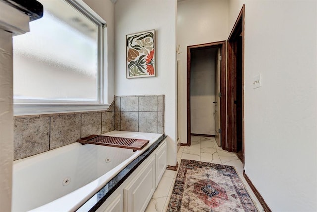 17009 Picasso Dr, Oklahoma City, OK 73170 - bathroom with marble look tile flooring and a tub with jets