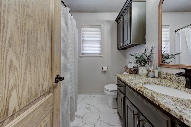 17009 Picasso Dr, Oklahoma City, OK 73170 - bathroom featuring marble finish floors, vanity, toilet, and baseboards