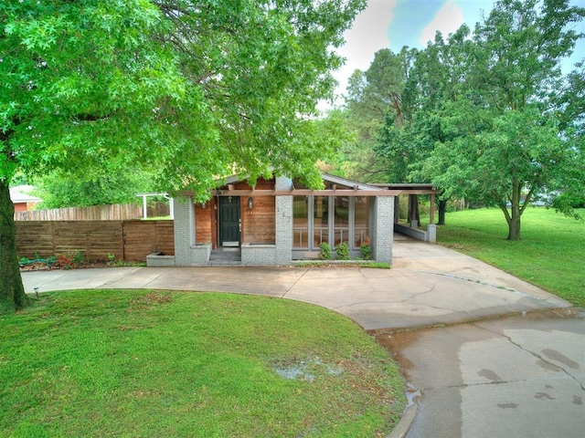 mid-century inspired home with brick siding and driveway